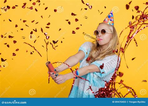 Portrait Of Funny Blond Woman In Birthday Hat And Red Confetti On