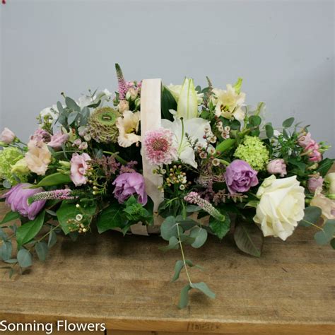 A common funeral choice made from green vines is the maile lei. Basket of flowers - funeral tribute | Sonning Flowers