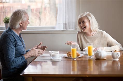 (play) in almost every country. Old Couple Having Fun Laughing Sitting Eating Breakfast In ...