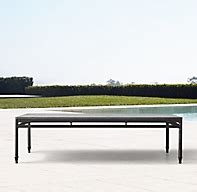 Modern chic meets antique with the catalan bronze gilded coffee table with glass top. Catalan Coffee Table