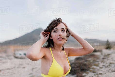 Woman In The Beach Wearing Yellow Swimsuit Stock Photo Dissolve