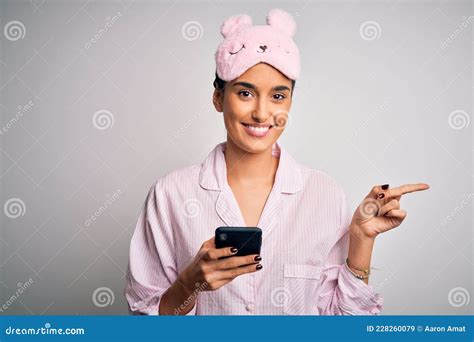 Young Beautiful Woman Wearing Pajama And Sleep Mask Having Conversation Using Smartphone Very
