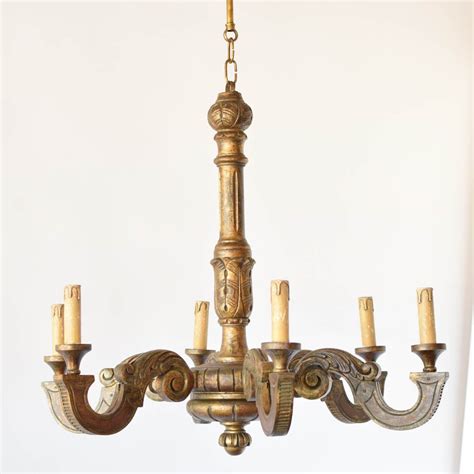 Finished in a cream color with weathered peeling off paint effect with dark bronze metalwork and six. Italian Painted Wood Chandelier - The Big Chandelier