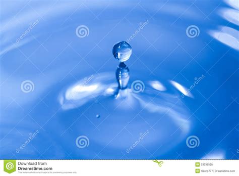 Water Drop Falling Into Water Making A Droplet Splash Stock Photo