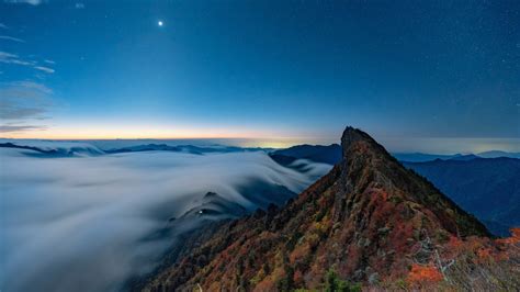 1366x768 Fog Covering Horizon Mountains Under Blue Sky 1366x768