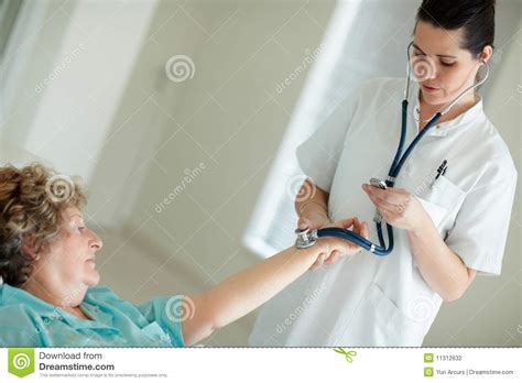 Nurse Checking The Pulse Of An Old Patient Stock Photo Image Of