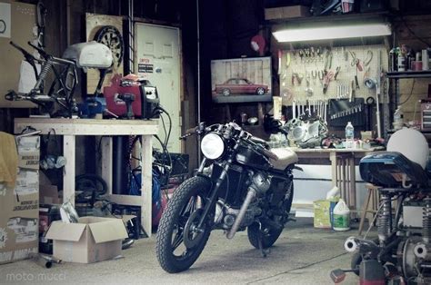 A Motorcycle Is Parked In A Garage Next To Other Bikes And Tools On The