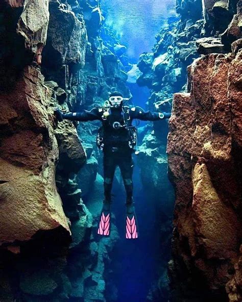 Diver Touching Two Continents Between North America And Europe Silfra Iceland Silfra A