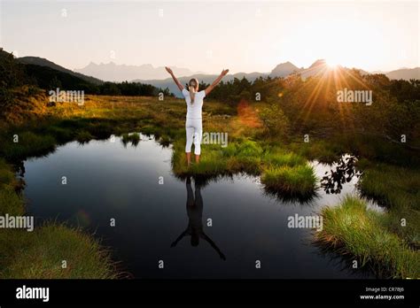Austria Salzburg County Young Woman Sitting Near Mountain Lake And