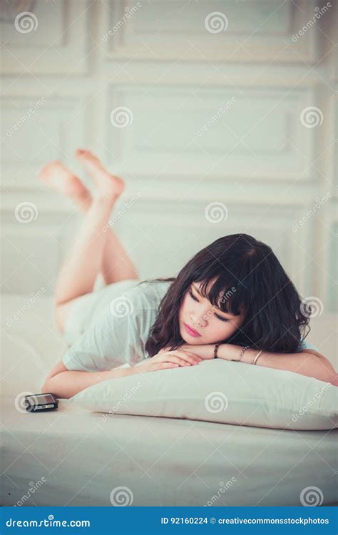 Asian Woman Lying Prone Listening To Music Picture Image 92160224