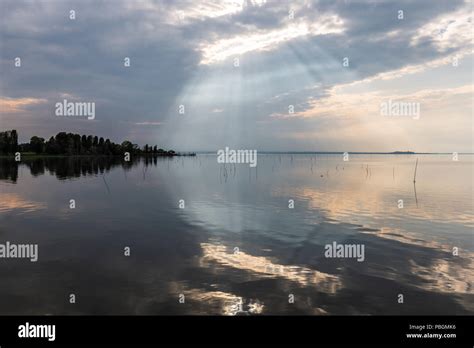 Perfectly Symmetric And Spectacular View Of A Lake With Clouds Sky