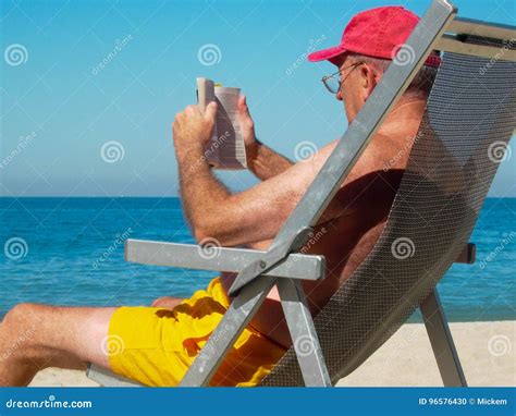 Man Reading Book On Beach Stock Photo Image Of Lonely