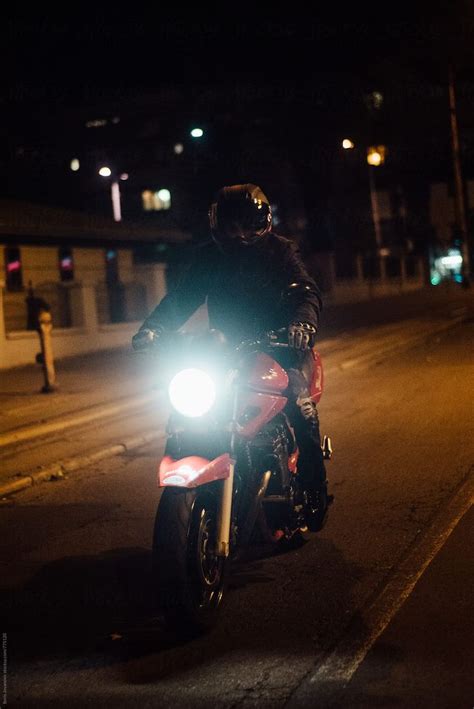 Biker Riding A Motorcycle On The Street At Night By Boris Jovanovic