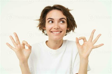 Image Of Excited Brunette Woman Smiles Shows Okay Ok Gesture Looks Amused And Happy Stands