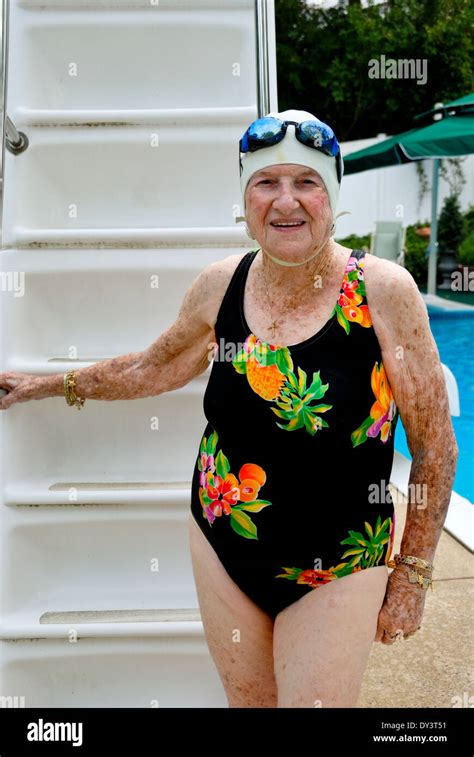 A Senior Citizen Woman In A Bathing Suit Swim Cap And Goggles Enjoys