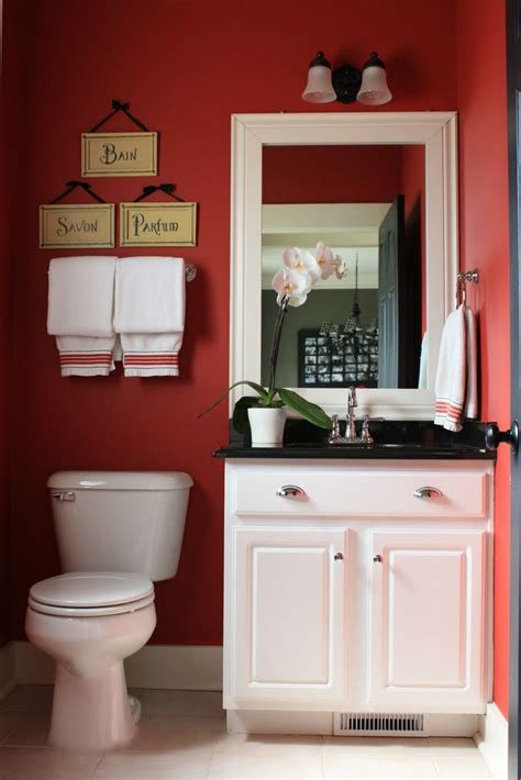 A White Toilet Sitting Under A Bathroom Mirror Next To A Sink In A Room