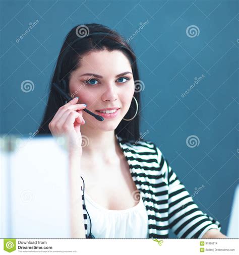 Beautiful Business Woman Working At Her Desk With Headset And Laptop