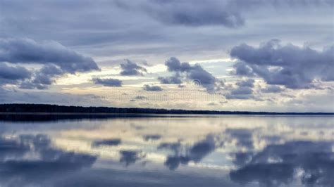 Dramatic Cloud Landscape On A Blue Sky Reflected In The River Stock