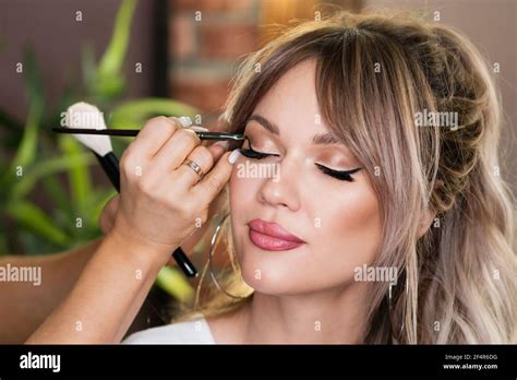 Makeup Artist Applies Eyeliner Beautiful Woman Face Hand Visagiste