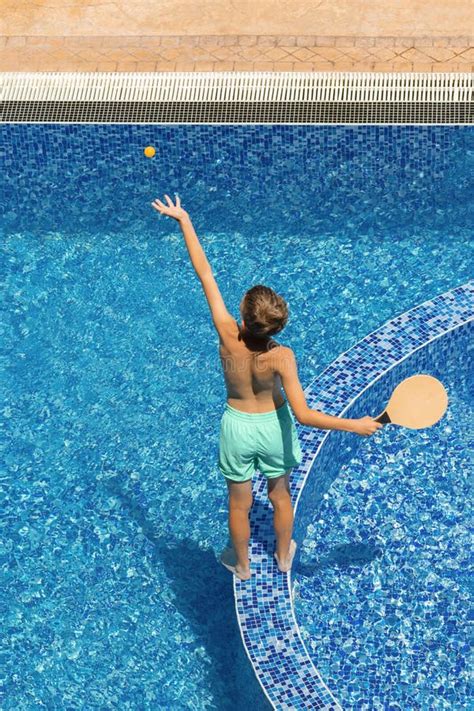Child Boy In Pool Playing Beach Tennis Summer Holidays Water Active