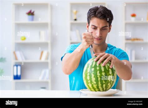 Man Eating Watermelon At Home Stock Photo Alamy