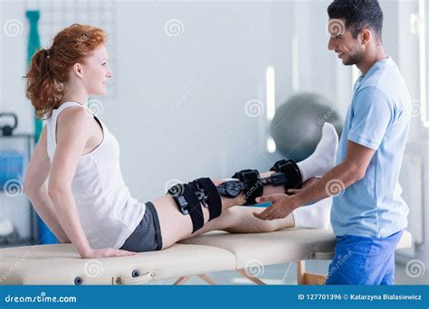 Doctor And Woman With Leg Injury During Treatment In The Hospital Stock