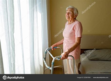 Elderly Woman Nursing Home Room Holding Walking Frame Wrinkled Hand