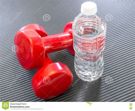 K9 crystal application opens image gallery. Two Red Dumbbell Weights Beside A Clear Bottle Of Water ...