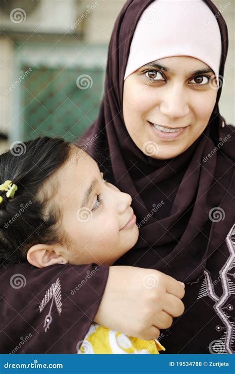 Arabic Mother And Son Sitting And Enjoying On Beach Pier Royalty Free