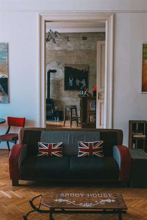 Cozy Living Room With Sofa With Uk Flag Cushions And Vintage Wooden