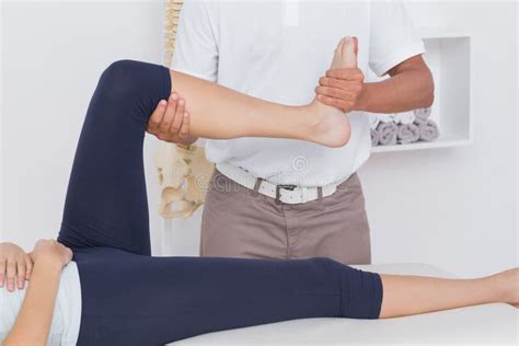 Physiotherapist Doing Leg Massage To His Patient Stock Photo Image Of