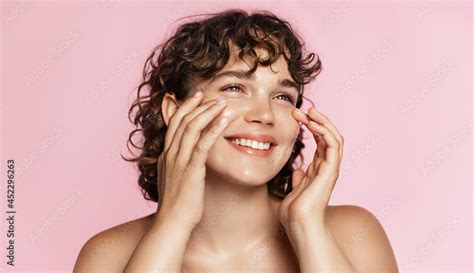 Beautiful Natural Girl Smiling Rubbing Her Face With Facial Cleanser