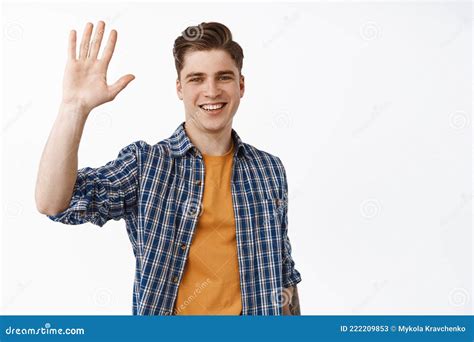 Portrait Of Friendly Smiling Man Waving Raised Hand Saying Hello And