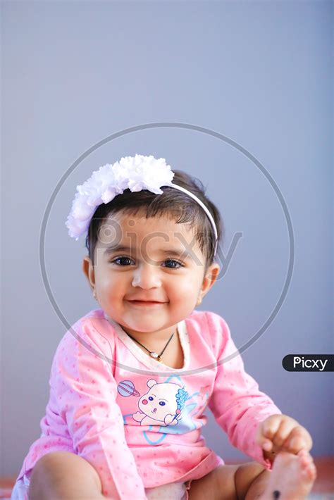 Image Of Cute Indian Baby Girl With Smiling Face On An Isolated White