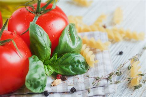 Italian Food Background With Tomatoes Basil Pasta Olive Oil Peppercorns