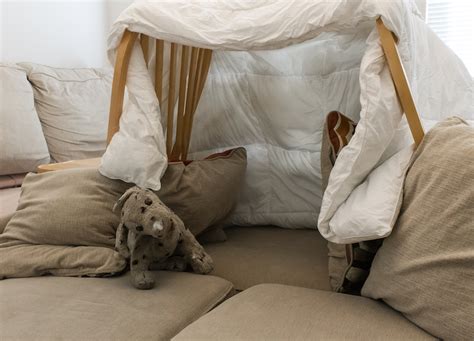A Pillow Fort Made Of Blankets Chairs With A Stuffed Animal In The