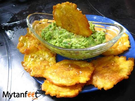 Some Fried Food On A Blue Plate With Guacamole In The Bowl And Chips