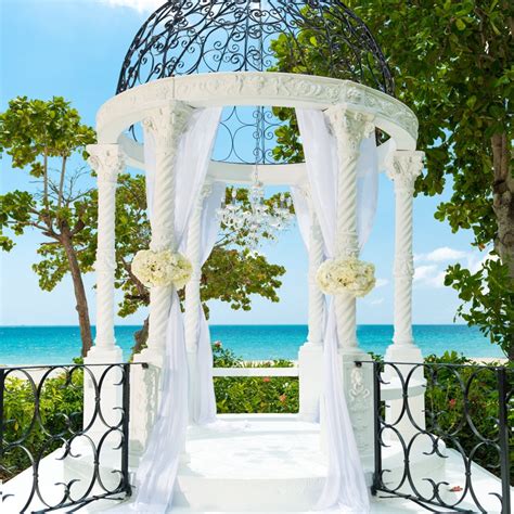 pillars of love adorn weddings on the beach at sandals royal barbados photo credit sandals