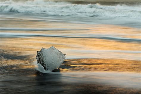 Iceberg On Black Sand Beach With Heavy Waves Passed In Early Morning At