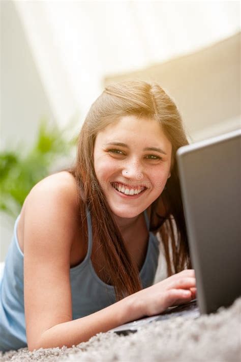 Happy Young Woman Lying On A Carpet With A Laptop Stock Image Image