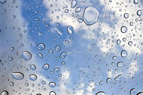 Sky And Clouds Through Large Raindrops On Window Background Stock Photo