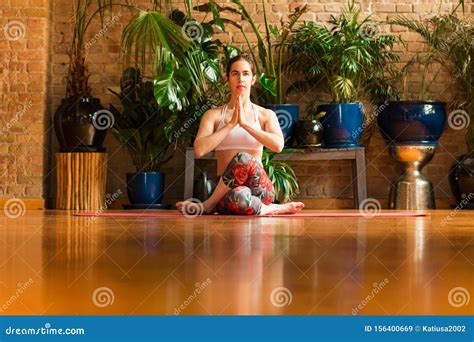 Slim Young Woman Practicing Yoga In Studio Asana Garudasana Stock