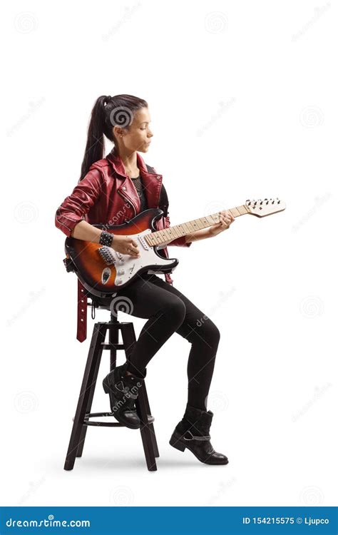 Young Female Musician Sitting On A Chair And Playing Electric Guitar