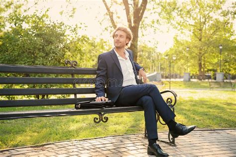Handsome Young Businessman Resting On Bench In Park Stock Photo Image