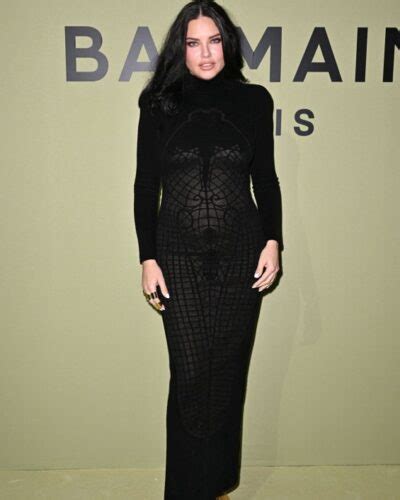 adriana lima highlighted her pregnant belly in a tight dress at a fashion show in paris