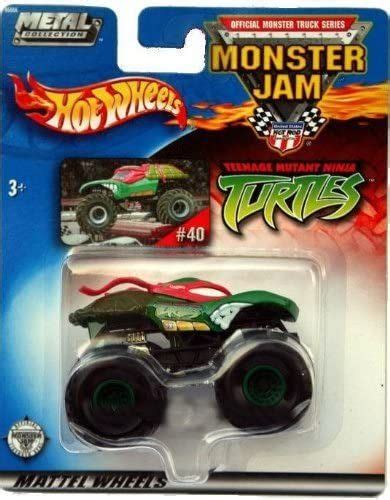 A Green Monster Truck With Flames On It S Front And Back Wheels In The