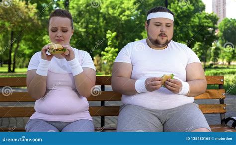 Fat Young Couple Eating Hamburgers Addicted To Junk Food Lack Of