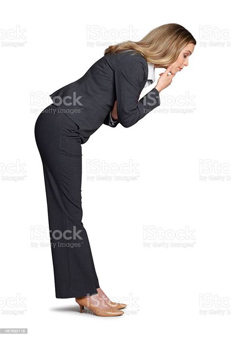 Businesswoman Bending Over And Looking Into The Unknown Stock Photo