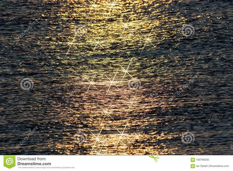 Sparkling Stars Of Sunlight Reflecting Off Calm Sea Water At Sun Stock