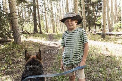 Seven Year Old Boy Walking His Dog In Forest Of Aspen Trees — Getting